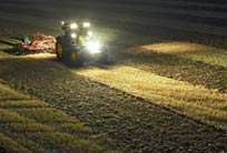 AMS: John Deere tractor in field using AutoTrac